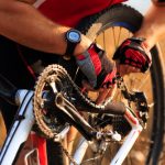 Bike,Repair.,Young,Man,Repairing,Mountain,Bike,In,The,Forest