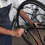 Bicycle,Repair.,A,Bike,Tech,Making,Adjustments,To,The,Derailleur