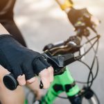 Cropped,Shot,Of,Cyclist,Hand,Wearing,Glove,And,Holding,A