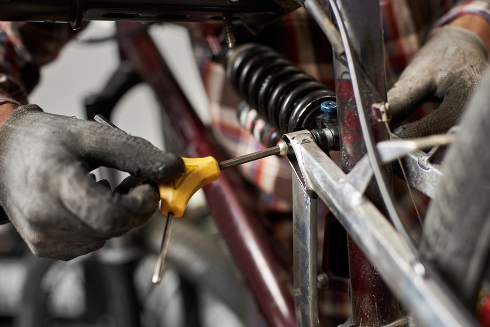 Cropped,Shot,Of,Man,Mechanic,Working,In,Bicycle,Repair,Shop,
